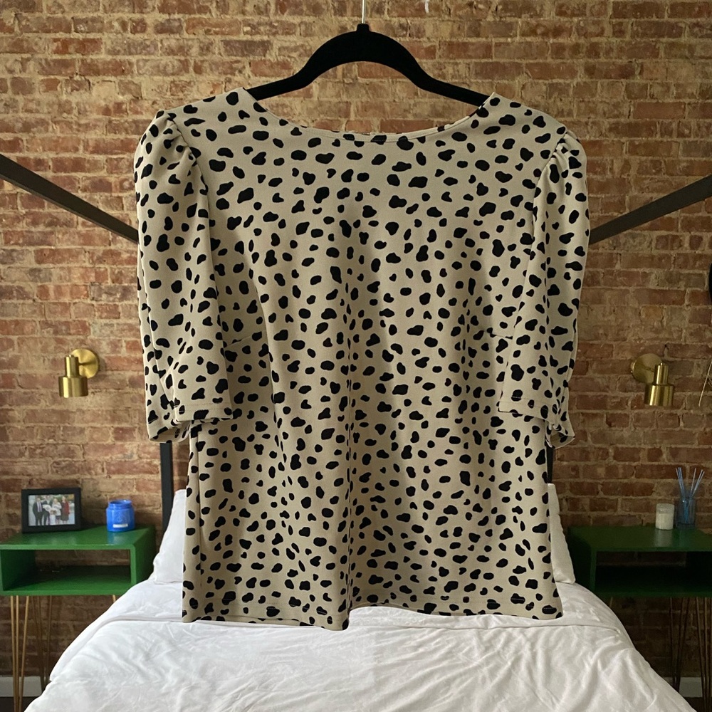 Melloday blouse with gold accent zipper.
